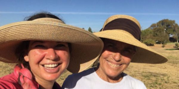 Picture of Sarah and Laurie in hats, smiling, during cross-country outing.