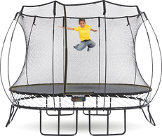 a boy in yellow t shirt is jumping on Springfree trampoline