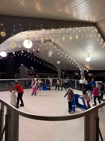 Children using skating aids at Christmas in the Ville.