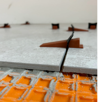 tile construction project with grout and tile spacers