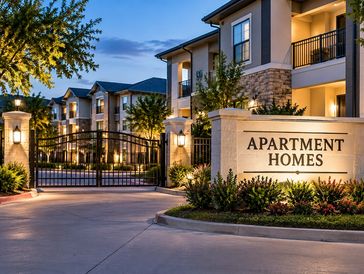 Entrance to a modern apartment complex at dusk.