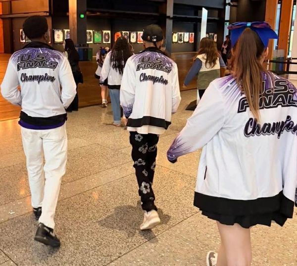 People in jackets labeled U.S. Finals Champions.