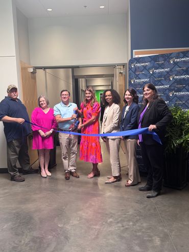 Group ribbon-cutting ceremony at Piedmont facility.