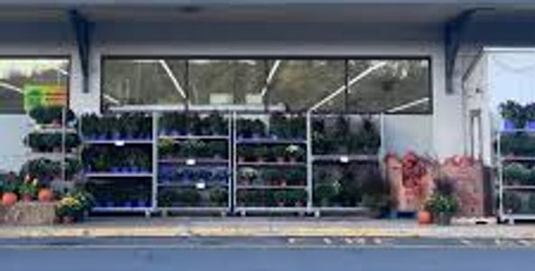 Exterior of a supermarket with a sign reading 'Gold Town Supermarket'.