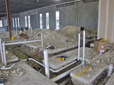 Construction site with plumbing pipes installed.