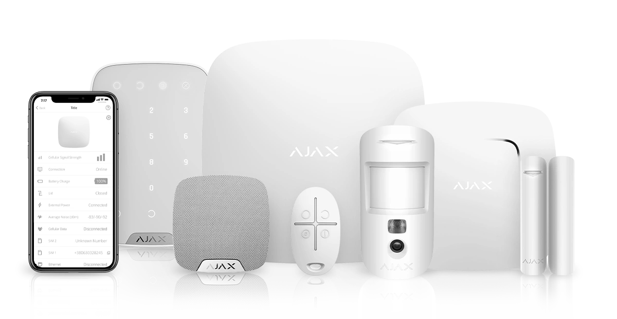 Stack of books next to pencils in a holder and a camera.