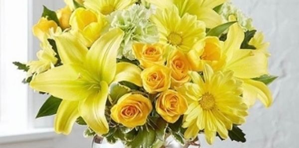 "Bowl of Sunshine" fresh flower design with lilies, roses, daisies and carnations.