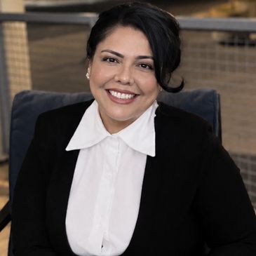 Smiling woman in business attire.