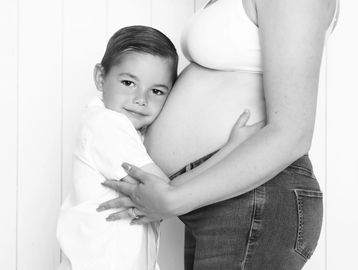 kid hugging pregnant woman