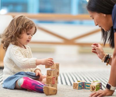 child working on fine motor skills occupational therapist in a home therapy session in Phoenix AZ