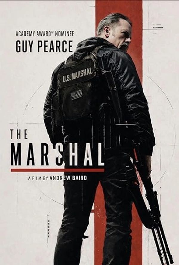 Movie poster of Guy Pearce in The Marshal holding a rifle, facing away.