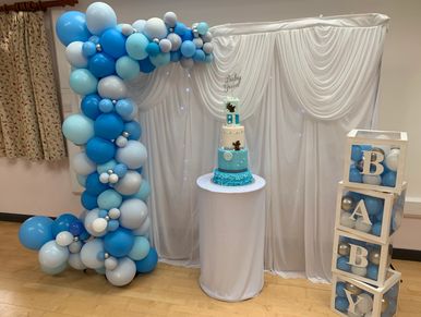 Deco Arch with Twinkle light backdrop and cake plinth with Baby Boxes 