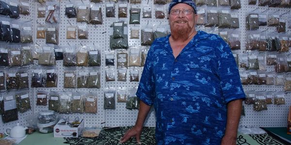 Roland in front of a Herb set up at a festival Highwinds Herbs