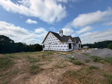 House under construction with wrapped exterior.