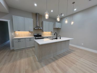 Modern kitchen with white cabinets and island.