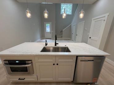Modern kitchen island with sink and appliances.