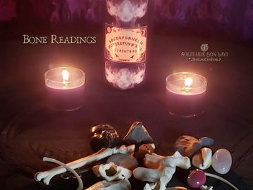 Candlelit setting with bones and mystical objects for readings.