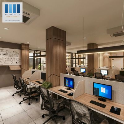 Modern office workspace with computer desks and ergonomic chairs.