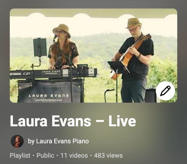 Laura Evans performing live with keyboard and guitar outdoors.