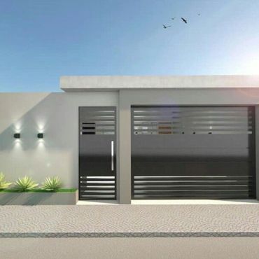 Modern house entrance with sleek gray gate and door under clear blue sky.