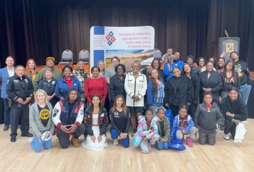A group of community members at town hall community event smiling and grouped together