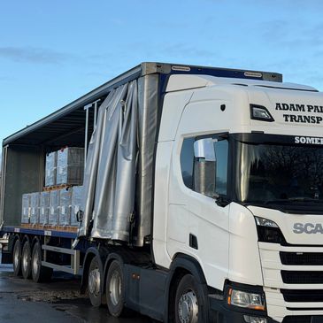 Curtainside vehicle offloading roof tiles for the building trade.