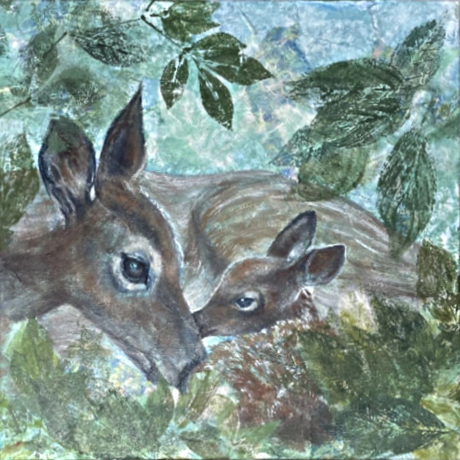 Two deer resting among green leaves and foliage.