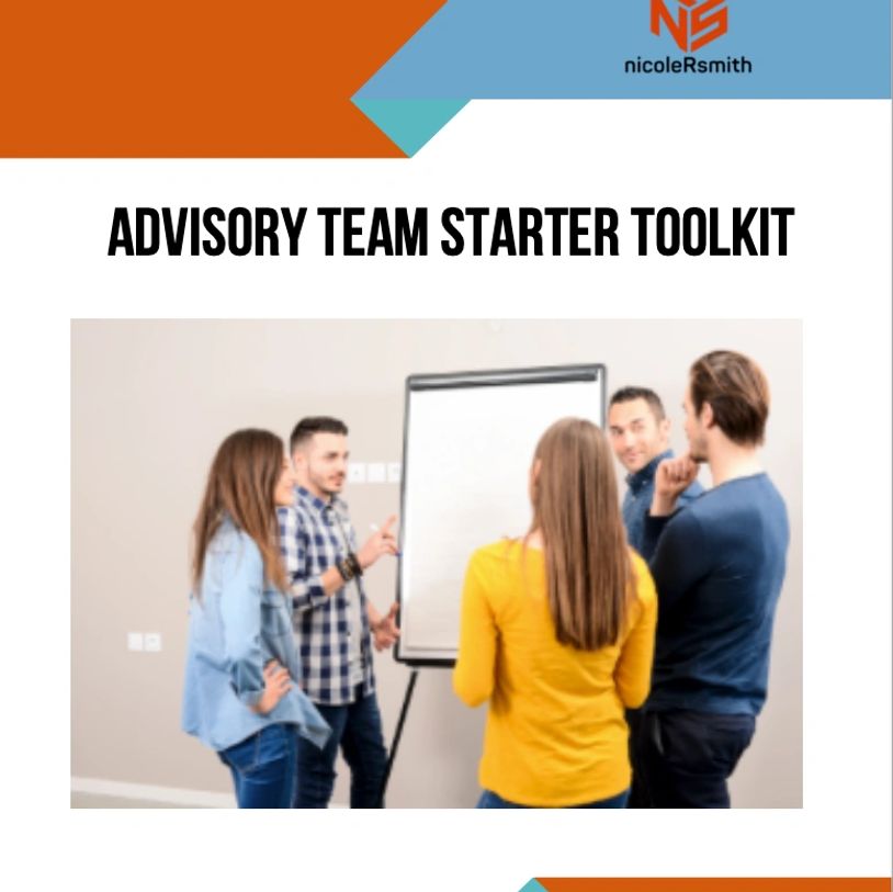 Team of four discussing ideas around a flip chart in a meeting room.