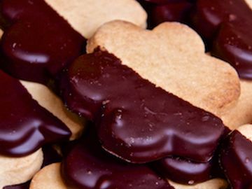 Sugar-free shortbread flower-shaped cookie dipped in chocolate 