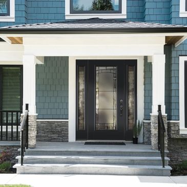 Modern front porch with a black framed glass door.