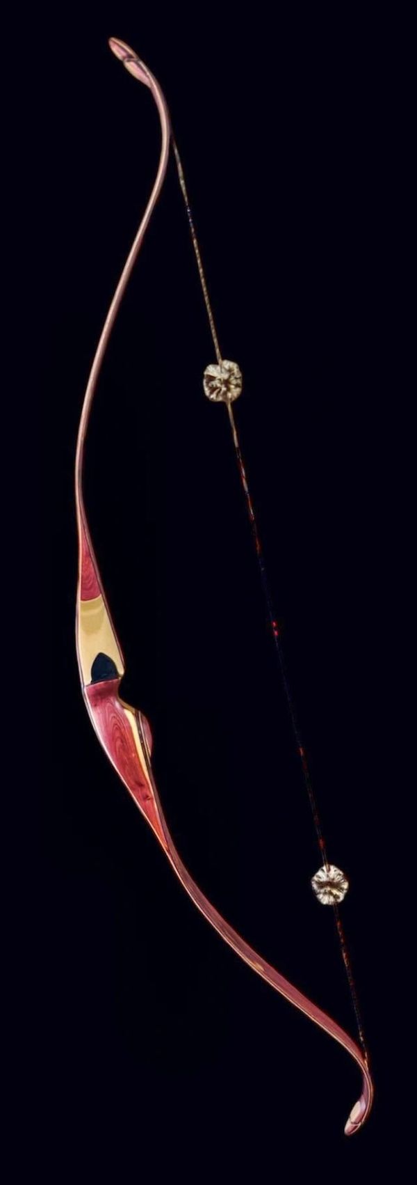 Traditional wooden recurve bow with string silencers.