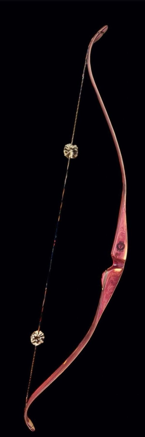 Traditional wooden recurve bow with string silencers.