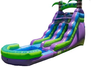 Colorful inflatable water slide with palm tree decorations.