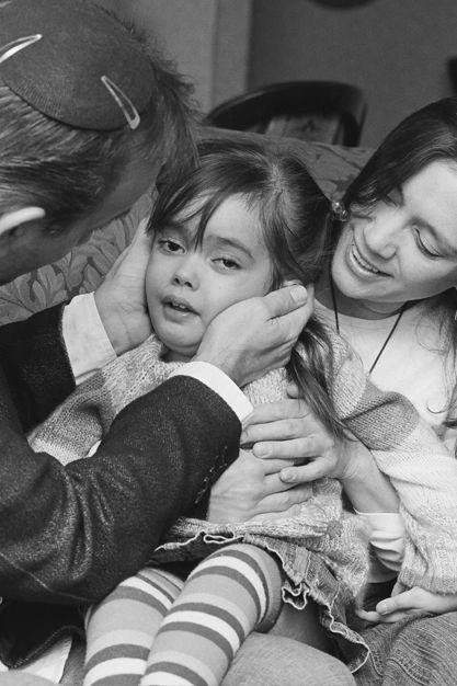 Rachaeli Fier, a now 8-year-old with Tay-Sachs disease with her parents