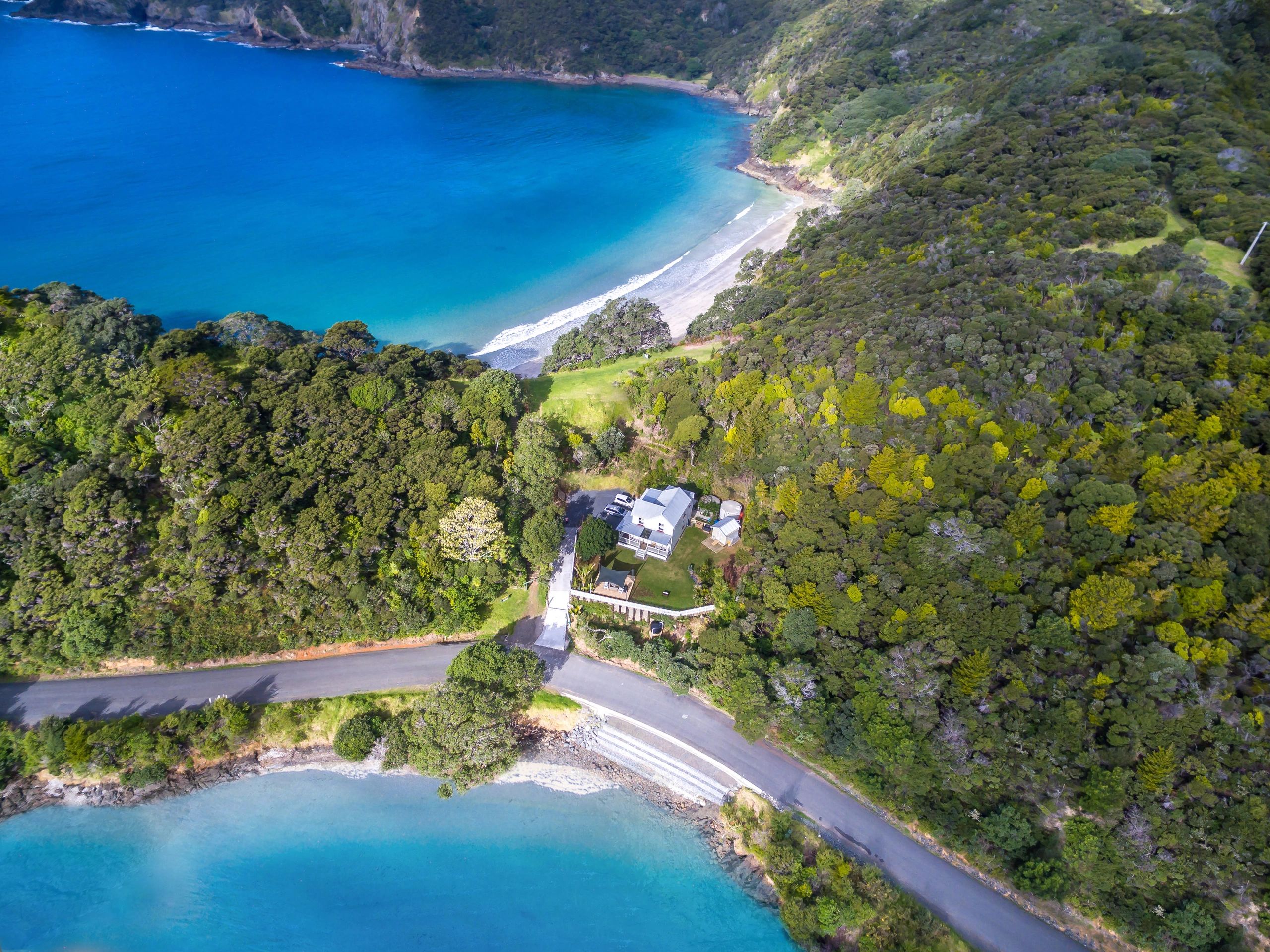And arial view  of the Lodge in relation to the two beaches. Oke Bay is at the rear of the Lodge. 