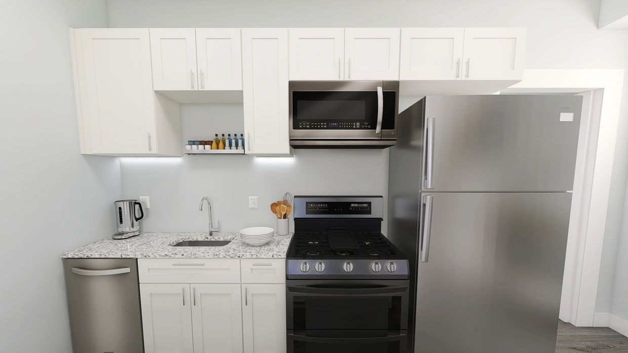 Modern kitchen with white cabinets, stainless steel appliances, and granite countertop.