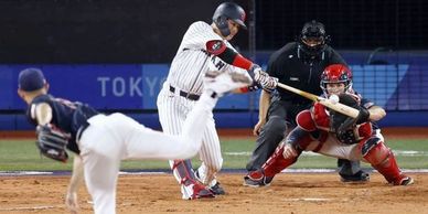 Male Baseball player at bat swinging at pitch. Athletic Rolfing aligns body for optimal performance.