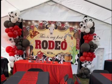 Full set up. Tablecloths, runner, seatcovers with sashes. Main table with backdrop balloon decor.
