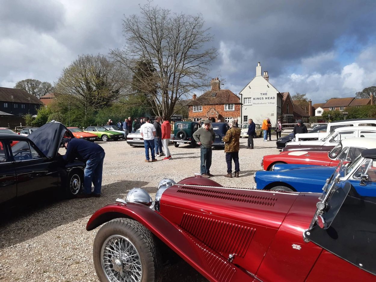 A gathering of vintage cars and enthusiasts at The Kings Head car meet.