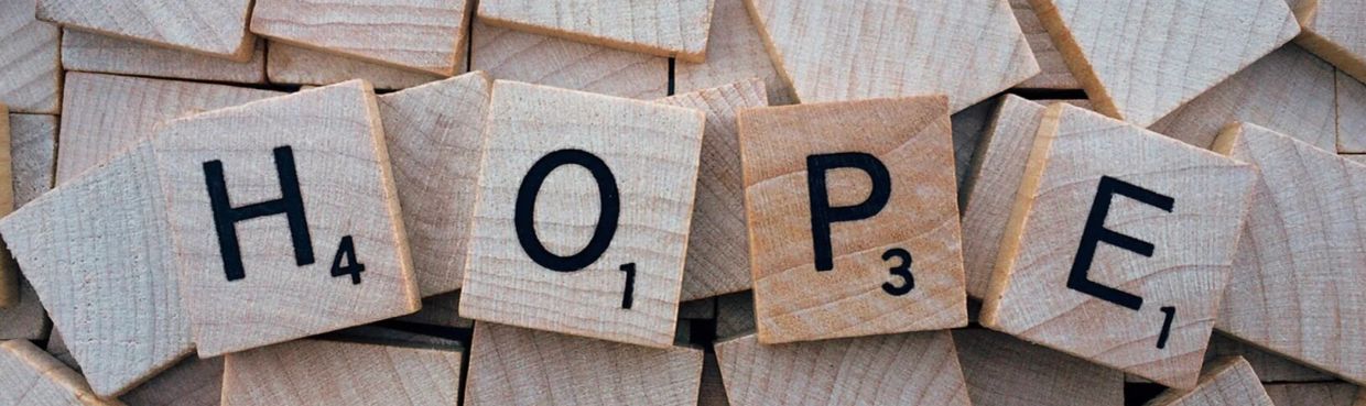 Scrabble tiles spelling the word HOPE.
