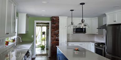 white kitchen cabinets & blue base cabinets for kitchen island with quartz top & crown molding