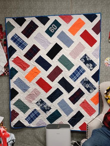 Colorful patchwork quilt with various patterns and a '60' patch.