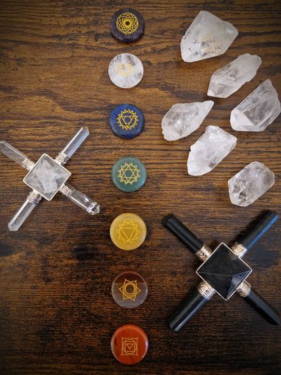 Set of chakra stones and crystals arranged on a wooden surface.