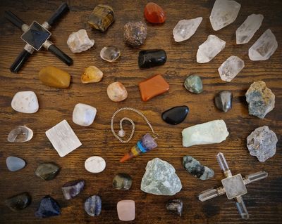 Various polished stones and crystals on a wooden surface.