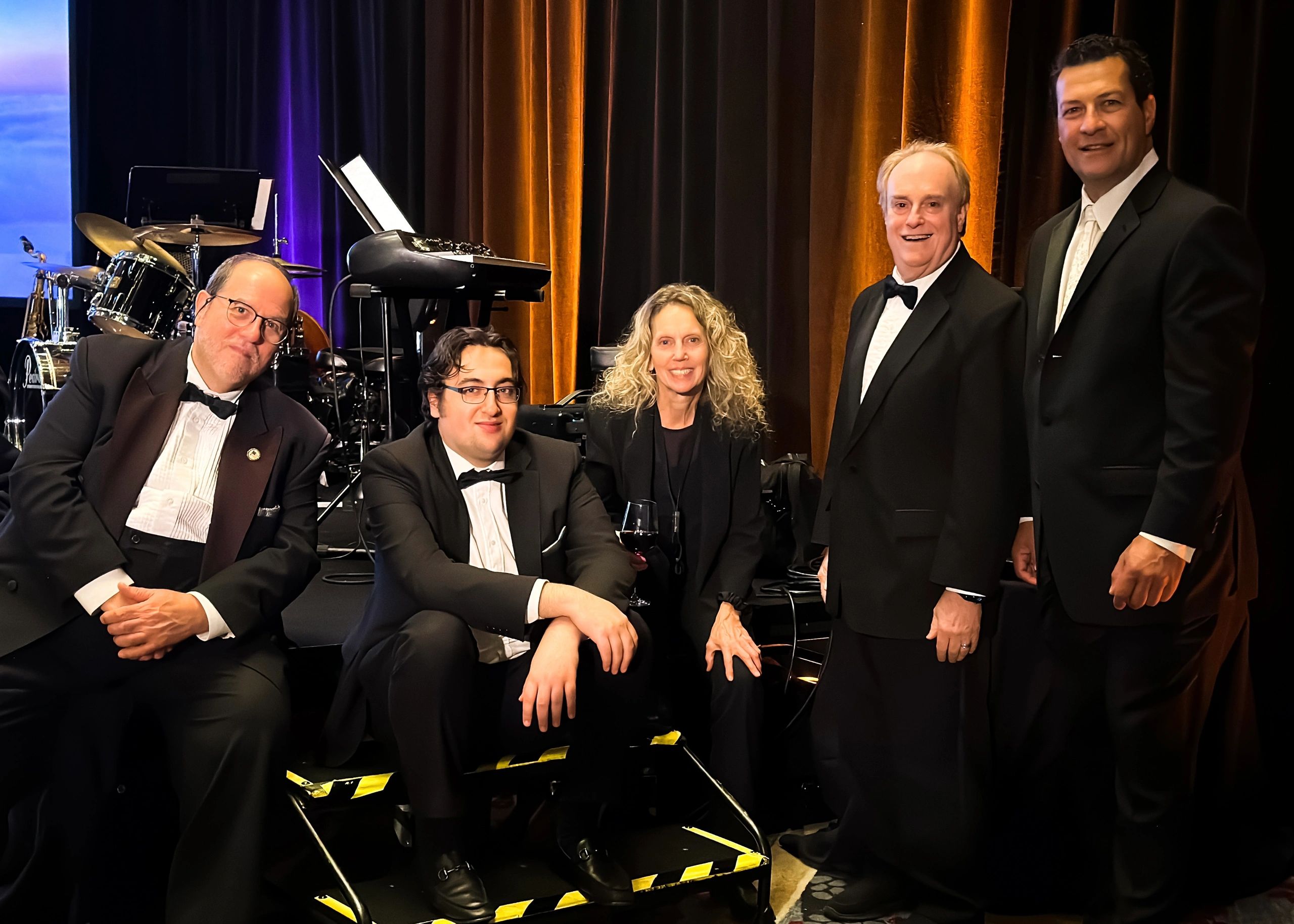 Dottoli posing with his Sinatra tribute quartet, dressed in formal wear for a live event performance