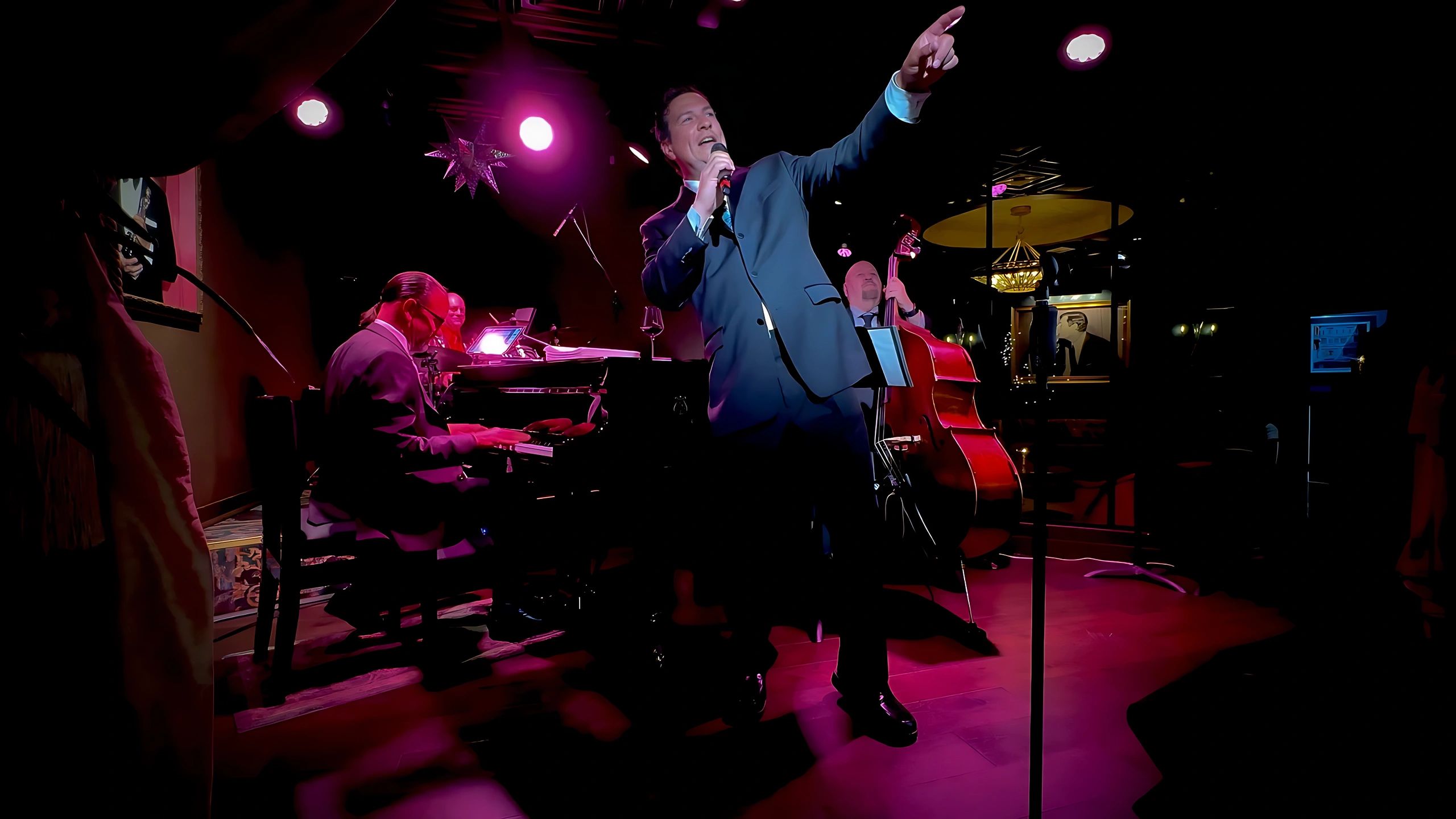 Lou Dottoli performing on stage with his trio band during a Rat Pack-style live show