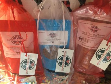 Three colorful bags of Pleasant Valley pet treats with tags.