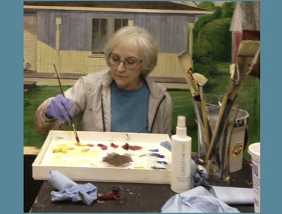 A woman doing painting on the paper