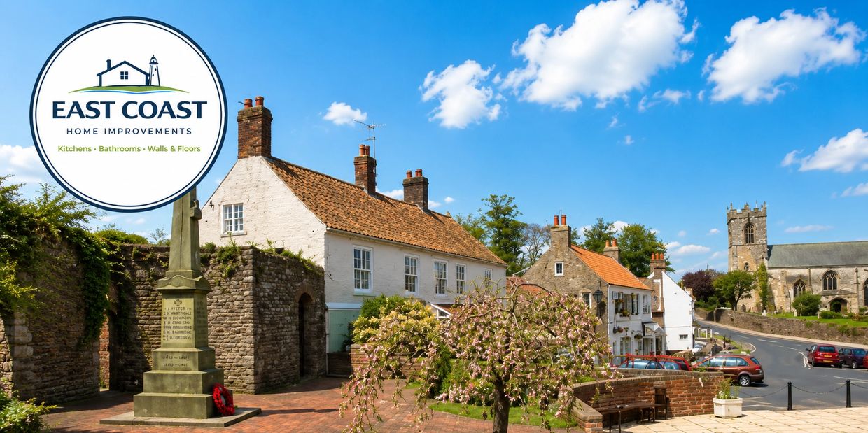 Quaint village street with historic buildings under a blue sky.