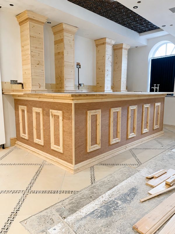 Bespoke timber bar under construction with decorative cast iron inserts and footrests in Scarborough